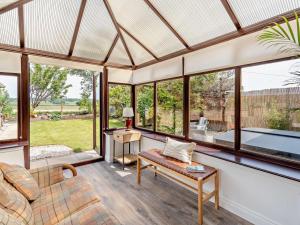 a living room with large windows and a couch at 3 Bed in Falkirk oc-96124 in Avonbridge