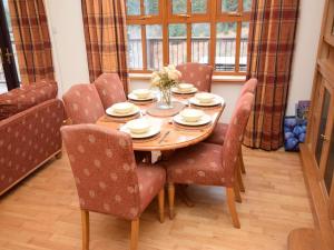 a dining room with a wooden table and chairs at 2 Bed in Lochgilphead oc-ca113 in Cairnbaan +9 photos