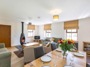 a living room with a table with flowers on it at 1 Bed in Lochgilphead oc-ca304 in Lochgilphead
