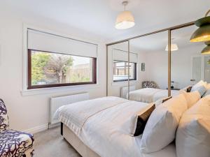 a bedroom with two beds and a window at 3 Bed in Falkirk oc-96124 in Avonbridge +32 photos