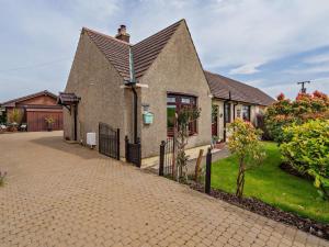 a brick house with a gambrel roof and a driveway at 3 Bed in Falkirk oc-96124 in Avonbridge