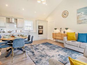 a kitchen and living room with a table and a couch at 2 Bed in Swansea oc-91728 in Killay
