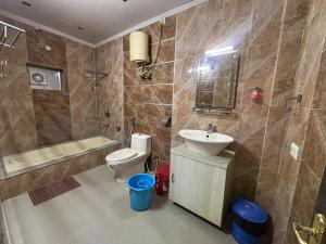 a bathroom with a toilet and a sink and a tub at Hotel Kep's - A Business Class Hotel in Contai +71 photos