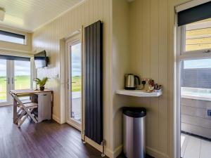 a room with a kitchen with a table and a window at 1 Bed in Girvan oc-78071 in Girvan
