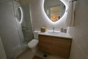 a bathroom with a sink and a toilet and a mirror at Modern & Cozy Studio for 2 in Saronida Steps from the Beach in Saronida +9 photos