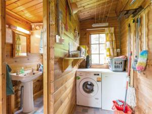 a bathroom with a washing machine and a sink at 2 Bed in Killin oc-ca351 in Ardeonaig +11 photos
