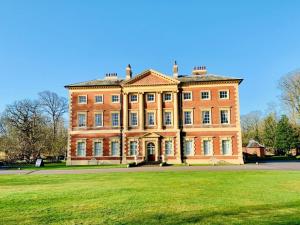a large brick building with a grass field in front at 1 Bed in Lytham St. Annes oc-86044 in Saint Annes on the Sea