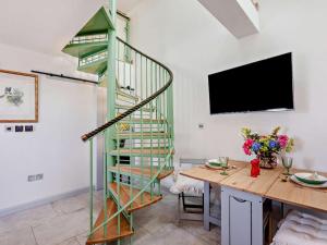 a spiral staircase in a living room with a table at 1 Bed in Gateshead oc-95877 in Lamesley