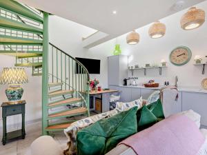 a living room with a couch and a spiral staircase at 1 Bed in Gateshead oc-95877 in Lamesley