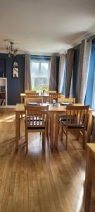 a dining room with wooden tables and chairs at Dubhlinn House Accommodation in Doolin