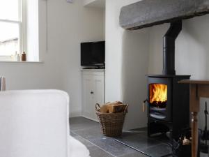 a fireplace in a living room with a stove at 1 Bed in Sedbergh oc-g0182 in Milnthorpe