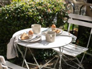 a table with two cups and plates of food on it at 1 Bed in Sedbergh oc-g0182 in Milnthorpe
