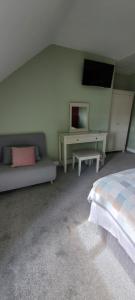 a bedroom with a bed and a tv on the wall at Dubhlinn House Accommodation in Doolin