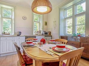a kitchen with a wooden table with chairs and a dining room at 2 Bed in Lochgilphead oc-ag577 in Kilmartin +15 photos