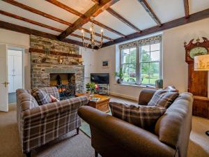 a living room with two couches and a fireplace at 2 Bed in Ulverston oc-94926 in Lakeside