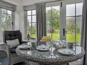 a living room with a glass table and chairs at 2 Bed in Ulverston oc-94926 in Lakeside