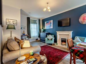 a living room with a couch and a fireplace at 1 Bed in Buckie oc-94536 in Cullen +12 photos