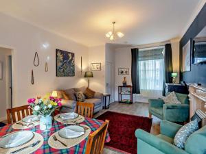 a living room with a table and a couch at 1 Bed in Buckie oc-94536 in Cullen