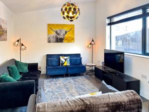 a living room with a couch and a tv at 3 Bed in Kinlochleven oc-87130 in Kinlochleven