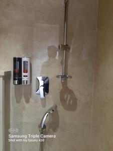 a shower in a bathroom with a shadow of a person at THE GRAND SUNCITY HOTEL AND RESORT, Bhopal in Bhopal +20 photos