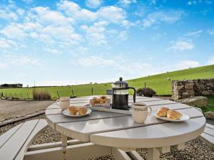 a table with plates of croissants and cups on it at 3 Bed in Isle Of Arran oc-ca099 in Sliddery