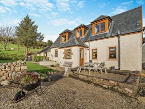 a large white house with a stone wall at 3 Bed in Isle Of Arran oc-ca099 in Sliddery