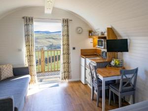 a kitchen and dining room with a table and a kitchen and a window at 1 Bed in Hawick oc-75347 in Hawick