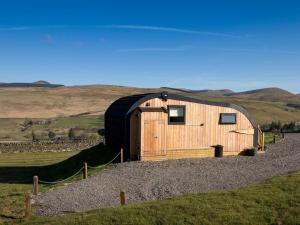 a wooden cabin with a dome roof on a hill at 1 Bed in Hawick oc-75347 in Hawick