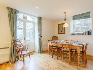 a dining room with a wooden table and chairs at 3 Bed in Achnasheen oc-ca120 in Inveralligin