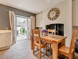 a kitchen and dining room with a table and a clock at 2 Bed in Grange-over-sands oc-83546 in Cartmel