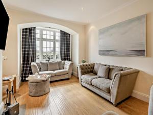 a living room with two couches and a table at 2 Bed in Grange-over-sands oc-83546 in Cartmel