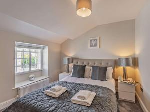 a bedroom with a bed with two towels on it at 2 Bed in Grange-over-sands oc-89206 in Cartmel
