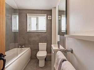 a bathroom with a toilet and a tub and a sink at 2 Bed in Grange-over-sands oc-89206 in Cartmel +9 photos