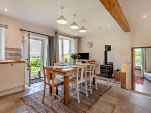 a kitchen and living room with a wooden table and chairs at 3 Bed in Penrith oc-94982 in Pooley Bridge