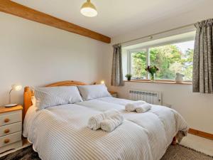 a bedroom with a bed with towels on it at 3 Bed in Penrith oc-94982 in Pooley Bridge