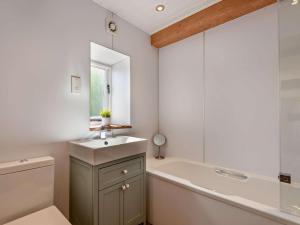 a bathroom with a tub and a sink and a bath tub at 3 Bed in Penrith oc-94982 in Pooley Bridge +15 photos