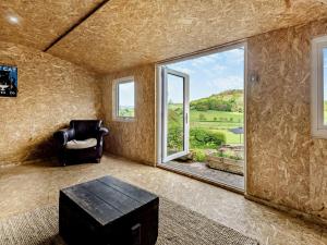 a living room with a chair and a large window at 3 Bed in Penrith oc-94982 in Pooley Bridge
