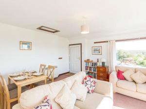a living room with a couch and a table at 2 Bed in Gairloch oc-ca137 in Big Sand