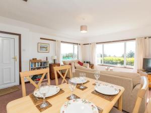 a living room with a table with wine glasses on it at 2 Bed in Gairloch oc-ca137 in Big Sand +17 photos