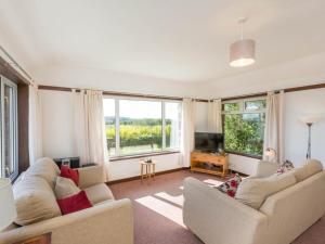 a living room with two couches and a television at 2 Bed in Gairloch oc-ca137 in Big Sand