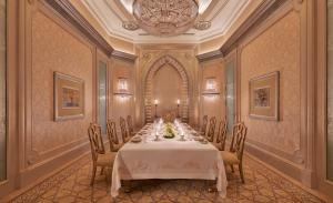 a dining room with a long table and chairs at Emirates Palace Mandarin Oriental, Abu Dhabi in Abu Dhabi