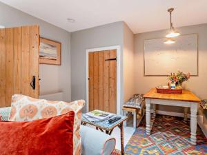 a living room with a table and a wooden door at 1 Bed in Duns oc-95832 in Duns