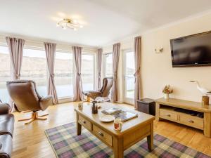 a living room with a couch and a table at 3 Bed in Isle Of Skye oc-81181 in Luib