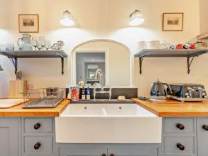 a kitchen counter with a sink and a mirror at 1 Bed in Duns oc-95832 in Duns +16 photos