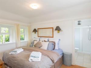 a bedroom with a large bed with two towels on it at 1 Bed in Brechin oc-ca217 in Edzell