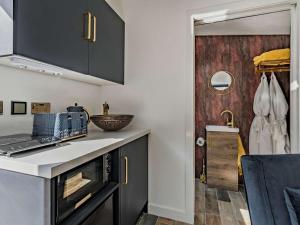 a kitchen with black cabinets and a counter top at 1 Bed in Kinlochleven oc-87131 in Kinlochleven +3 photos