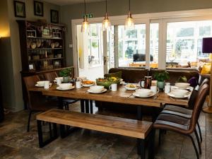 a dining room with a wooden table and chairs at 5 Bed in Lochgoilhead oc-ca279 in Carrick