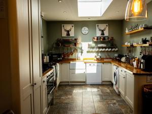 a kitchen with white cabinets and white appliances at 5 Bed in Lochgoilhead oc-ca279 in Carrick +25 photos