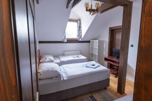 a small bedroom with a bed and a mirror at Penzion Novopacké Sklepy in Nová Paka +71 photos