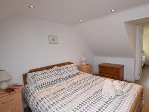 a bedroom with a bed with two slippers on it at 3 Bed in Isle Of North Uist oc-77239 in Sollas